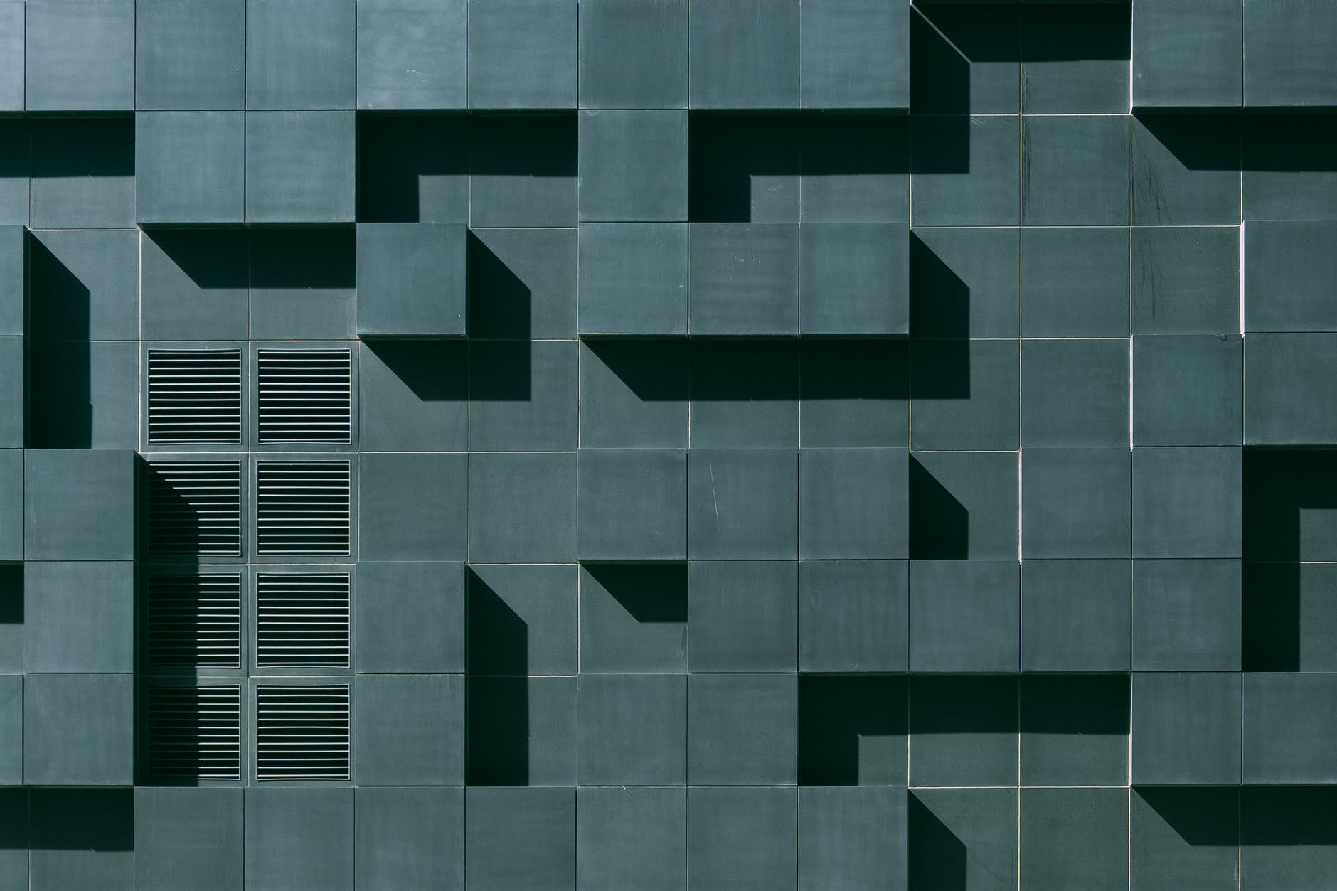 gray concrete building exterior with geometric design