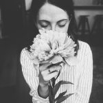 woman holding white flower