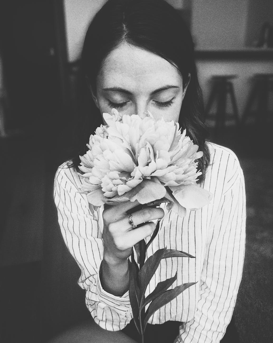 woman holding white flower