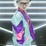 woman wearing black hat and colorful jacket