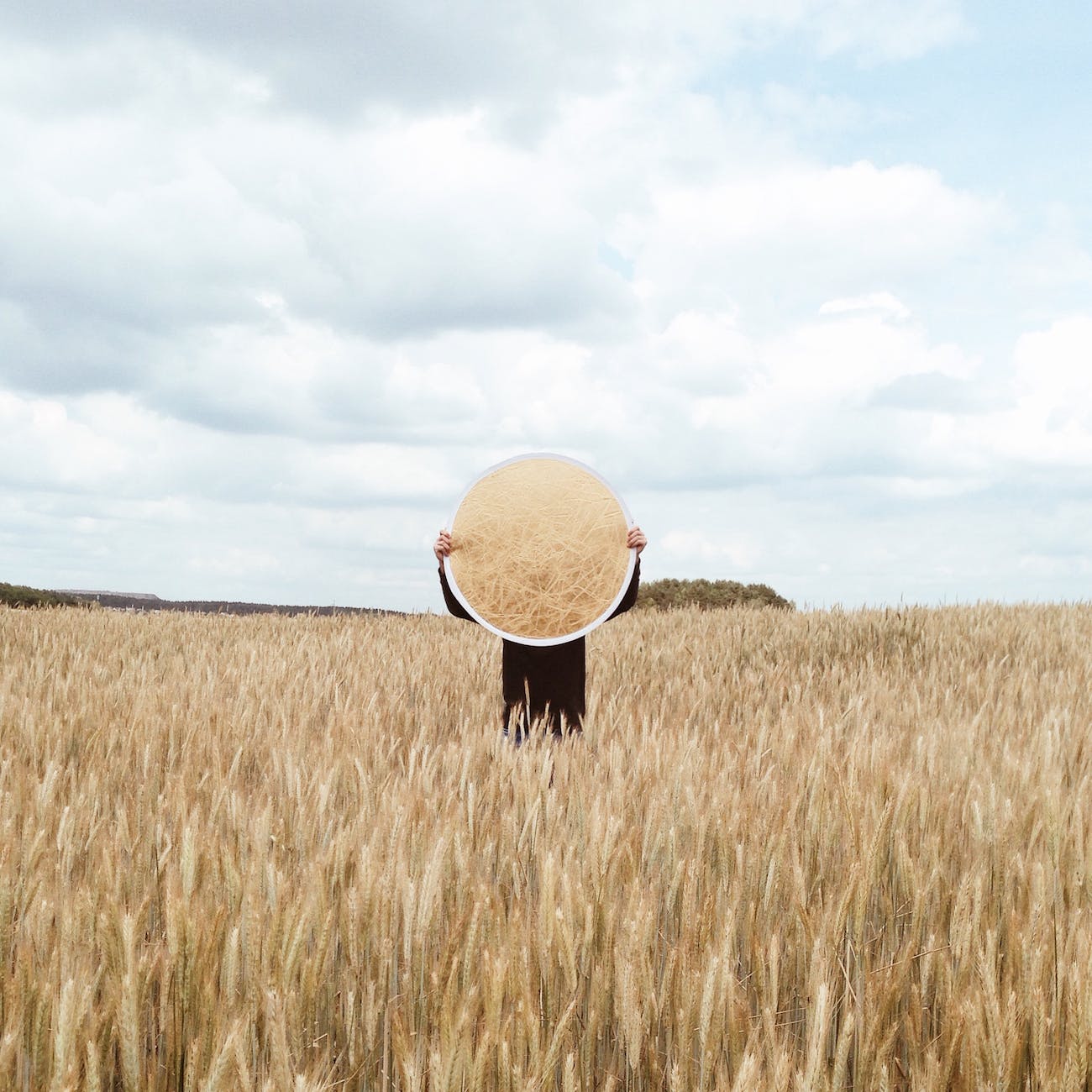person holding a mirror on an open field