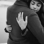 monochrome photo of woman hugging her man
