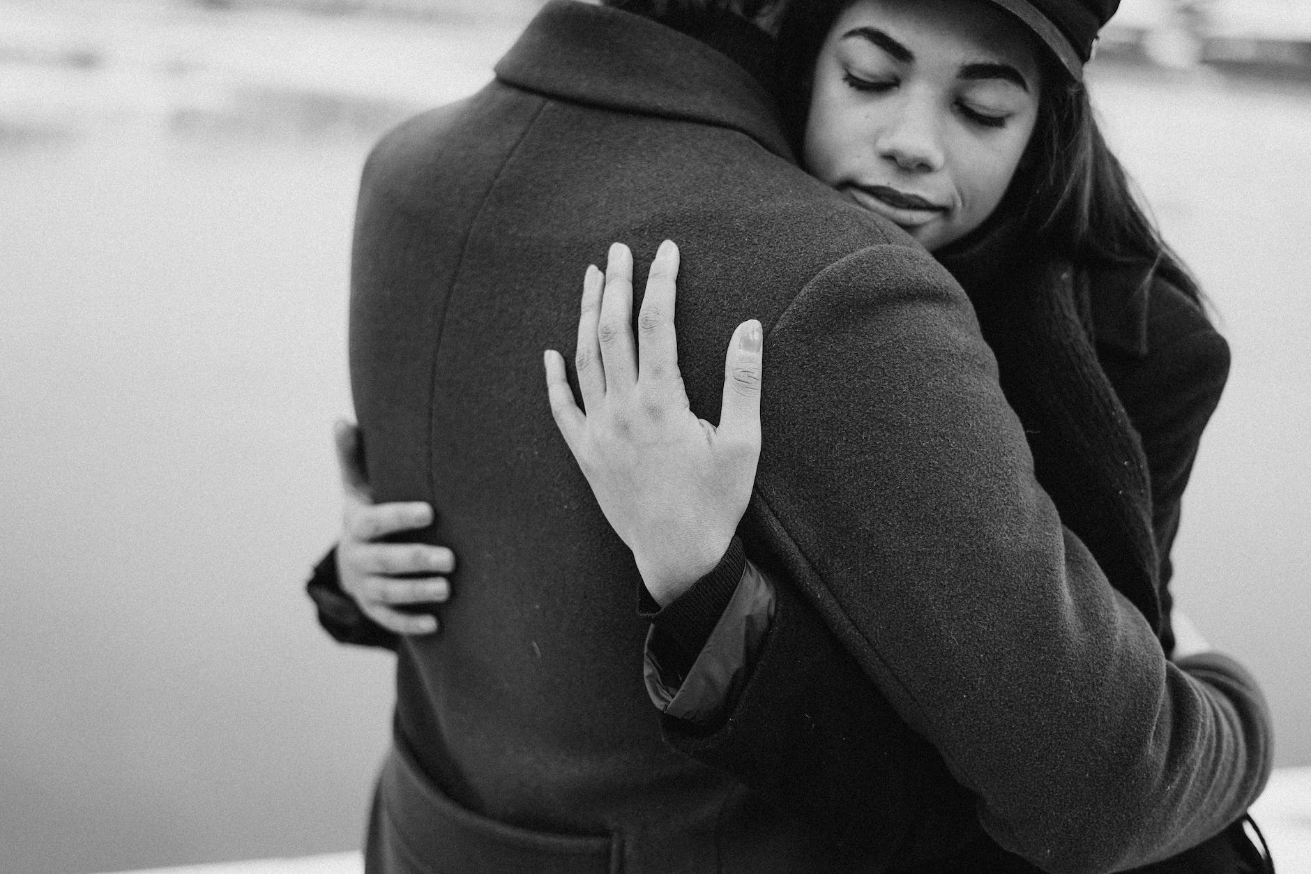 monochrome photo of woman hugging her man